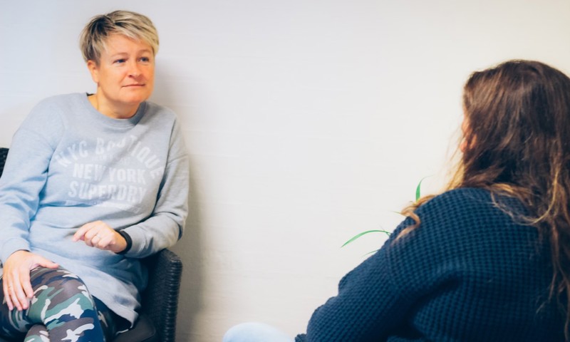 To kvinder sidder og taler sammen To kvinder sidder og taler sammen